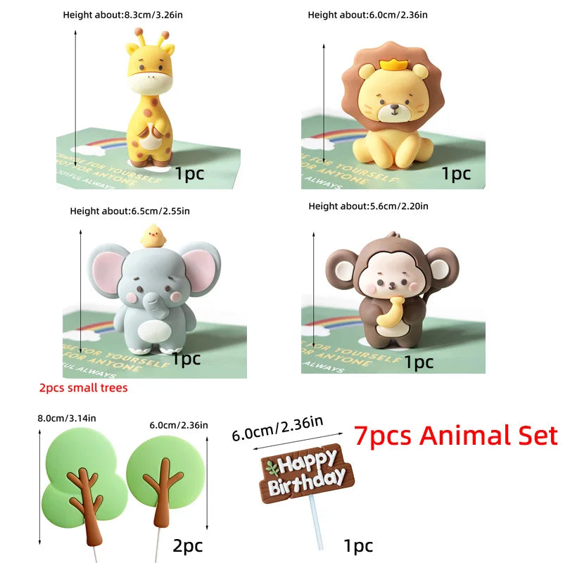 A set of seven animal cake toppers including a lion, elephant, and small trees