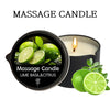A black massage candle labeled Lime Basil & Citrus with fresh lime slices nearby.