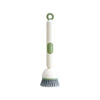 A white liquid washing brush with a green handle and bristles.
