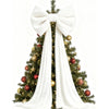 A velvet Christmas tree decorated with gold and red ornaments and a large white bow and long draping tails.