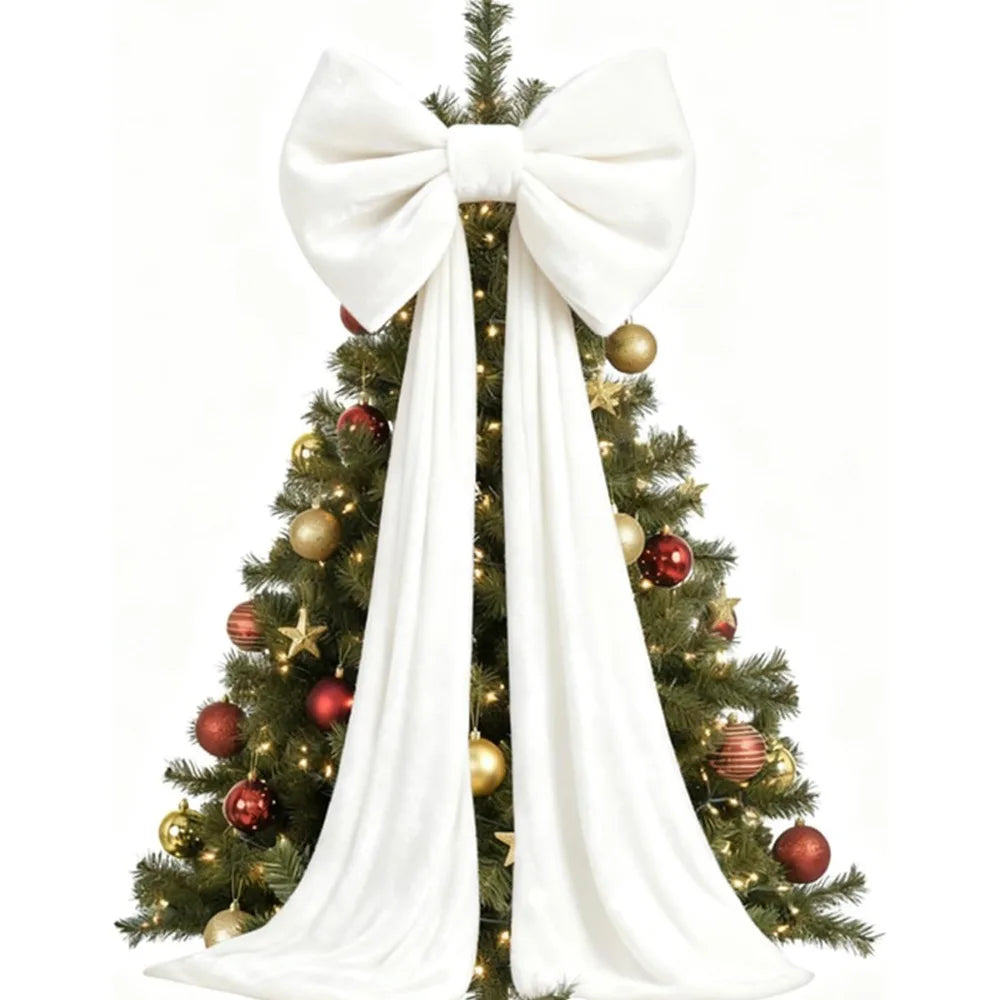 A velvet Christmas tree decorated with gold and red ornaments and a large white bow and long draping tails.