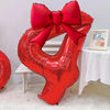 A large red foil number balloon shaped like the number 4, tied with a matching red bow.