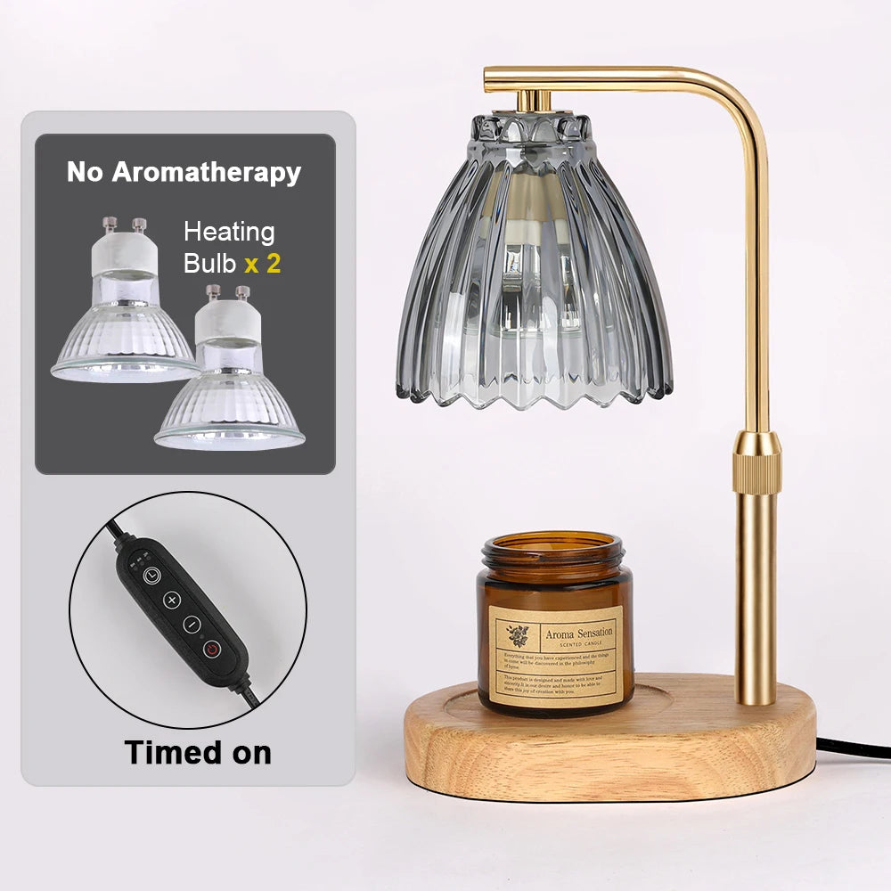 A gold-toned adjustable candle warmer lamp with a glass shade and heating bulbs, sitting on a wooden base.