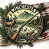 Vintage hunting scene metal wall sign featuring a deer and rifle silhouette against a mountainous landscape.