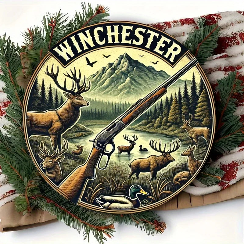 Vintage hunting scene metal wall sign featuring a deer and rifle silhouette against a mountainous landscape.