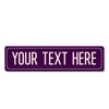 A purple rectangular metal street sign with the text YOUR TEXT HERE in white capital letters.
