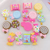 A collection of 20 colorful resin candy charms including lollipops, swirls, and candies for scrapbooking and jewelry making