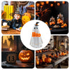 A collection of illuminated ghost figurines and carved pumpkins used for Halloween decoration.