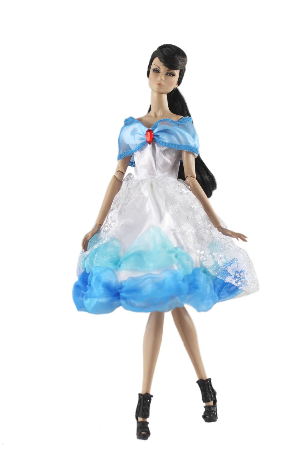 A handmade doll dress gown featuring white and blue layers with a sheer overlay and a ruffled neckline.
