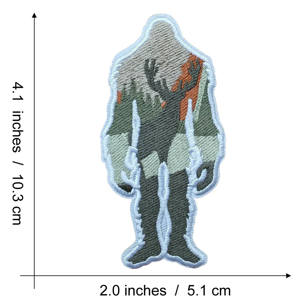 An embroidered patch depicting a silhouette of Bigfoot in an earthy green and brown color scheme.