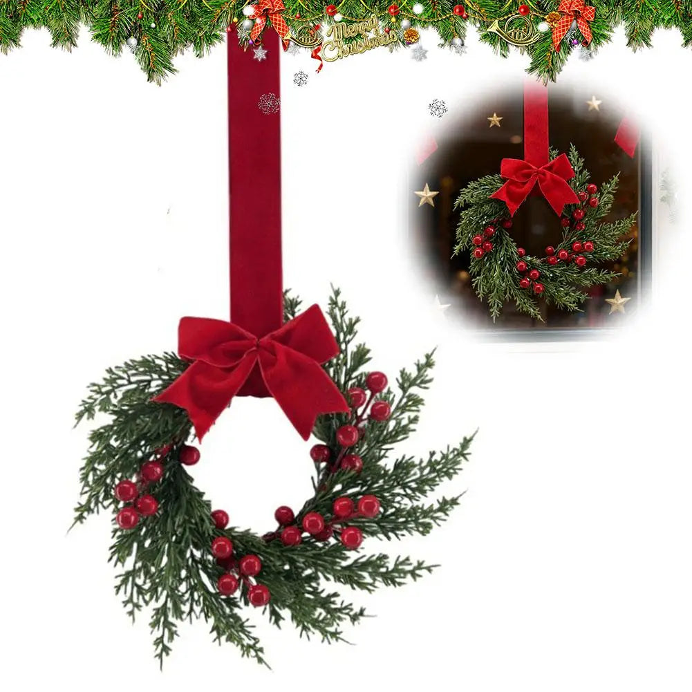 A 10-inch artificial Christmas wreath decorated with green foliage, red berries, and a large red velvet bow.