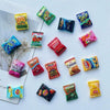 A collection of ten colorful, candy-shaped refrigerator magnets including Takis, Bugis, and Cheetos.