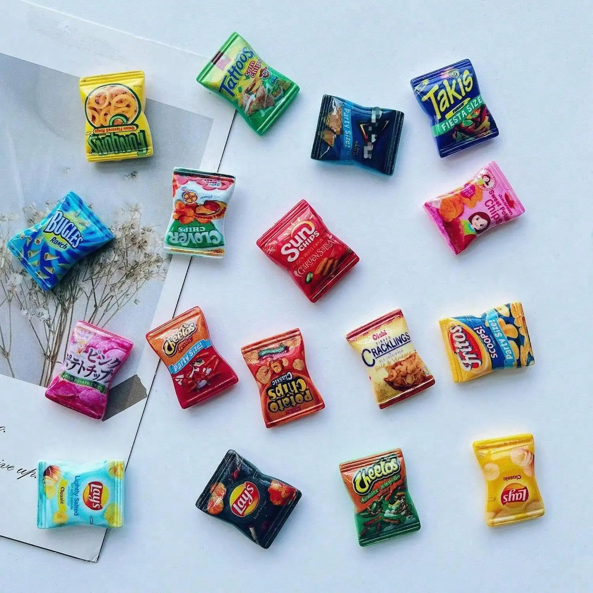 A collection of ten colorful, candy-shaped refrigerator magnets including Takis, Bugis, and Cheetos.