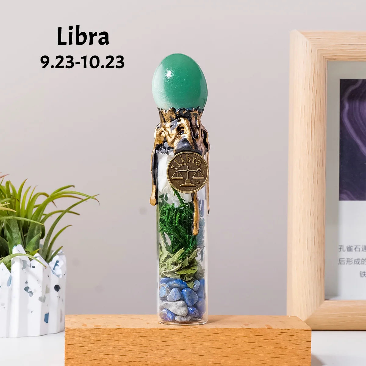 A glass bottle filled with natural healing stones and topped with a green crystal, representing the Libra zodiac sign.