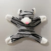 A plush toy resembling a striped cat with white accents and a pink nose.