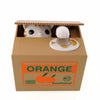A cardboard box containing an interactive coin bank with a white animal design and an orange label.