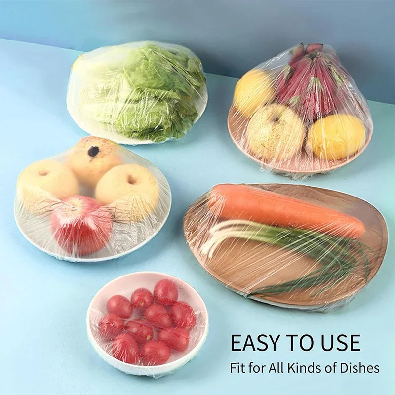 Reusable clear cling film used to wrap and store various fruits and vegetables like apples carrots and berries.
