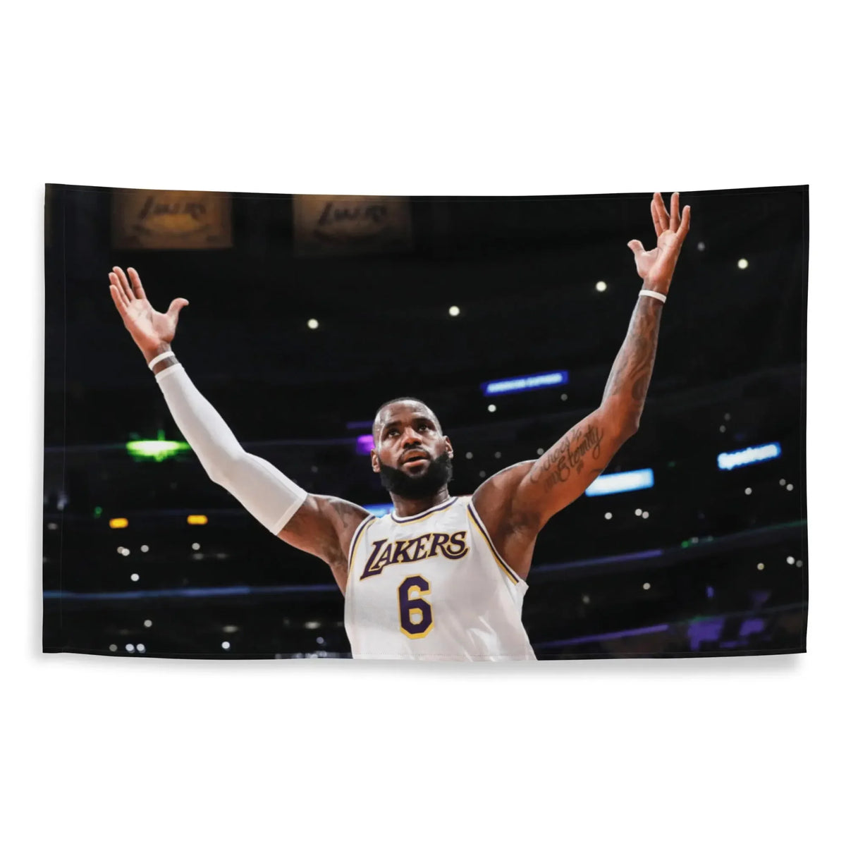 A photo of LeBron James in a Los Angeles Lakers jersey celebrating with his arms raised during a basketball game.