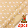 Roll of festive snowflake Christmas wrapping paper with a small brown reindeer decoration