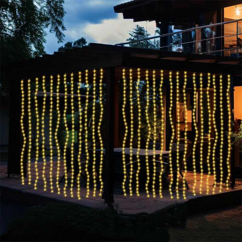 String lights draped like curtains illuminating an outdoor patio area at dusk.