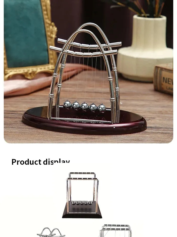 Silver Newton's cradle balance balls desktop decor featuring a metallic arch design on a wooden surface.