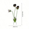A decorative metal carnivorous flower garden stake with three flower heads, shown vertically.