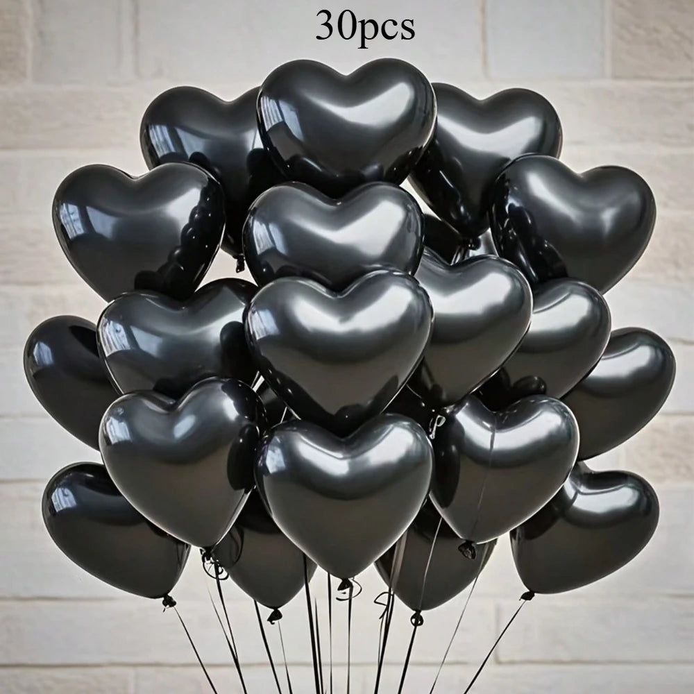 A bouquet of 30 glossy black heart-shaped latex balloons tied together.