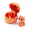 A 3D printed dragon egg with an open top revealing a small, golden-colored dragon toy.