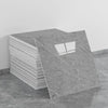 A stack of self-adhesive marble tile stickers, showing the texture and shape of the tiles.