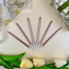 A set of 24 gradient blue metallic birthday candles arranged diagonally on a light background with green leaves.