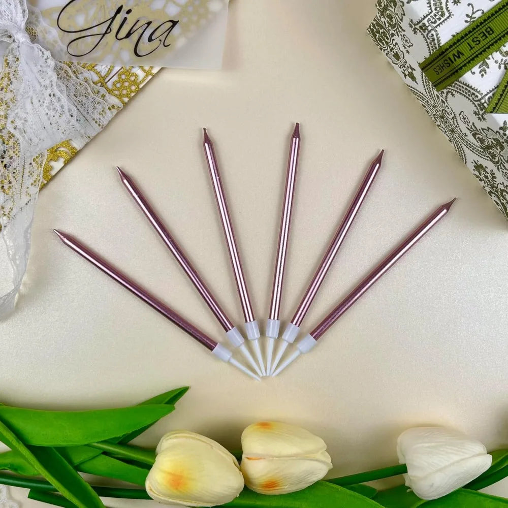 A set of 24 gradient blue metallic birthday candles arranged diagonally on a light background with green leaves.