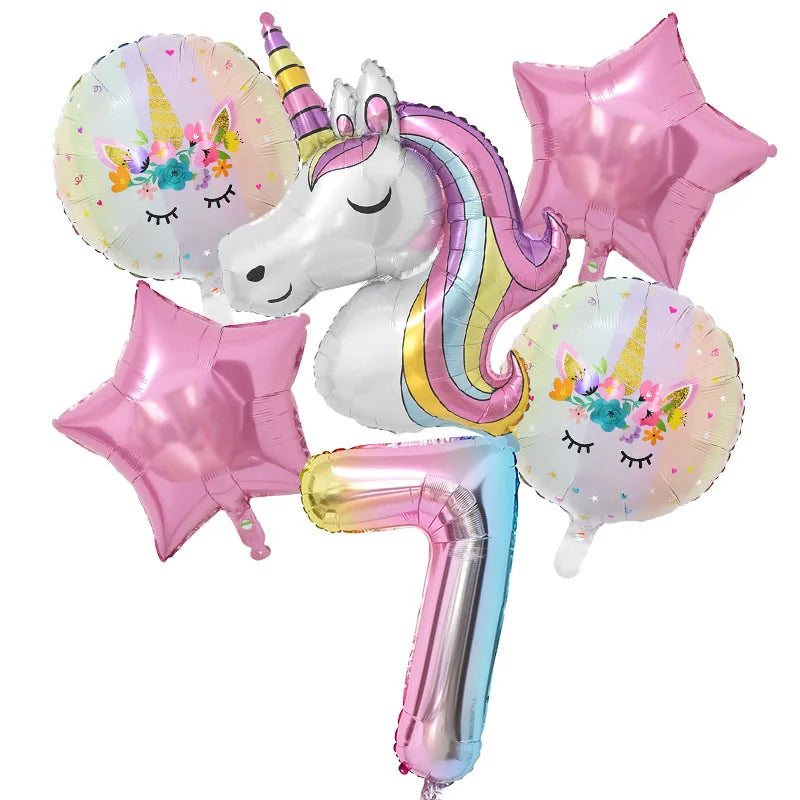 A collection of pink and iridescent balloons, including a unicorn balloon and star-shaped balloons, for a birthday party.