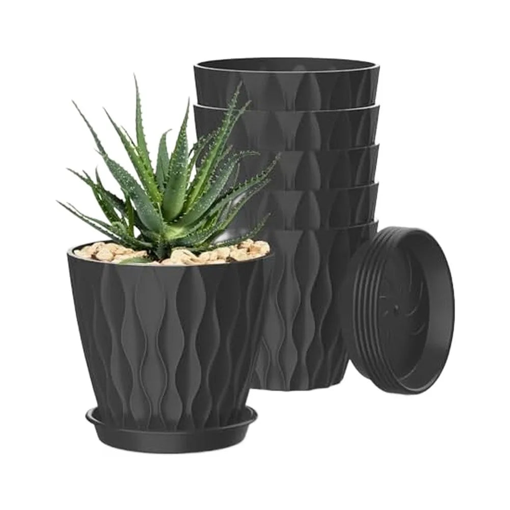A set of six black plastic round plant pots with drainage saucers stacked together.