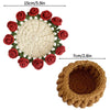 Hand-crocheted rose flower coasters featuring a cream center surrounded by red and green yarn.