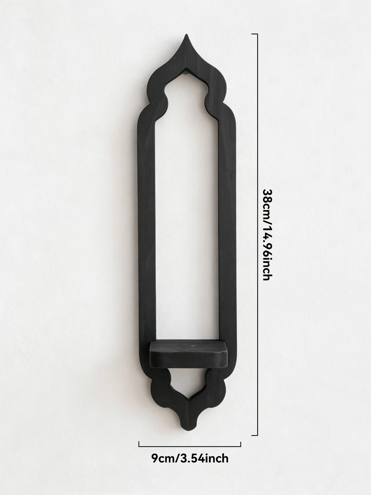 A black wooden arch-shaped wall shelf with a decorative top and bottom