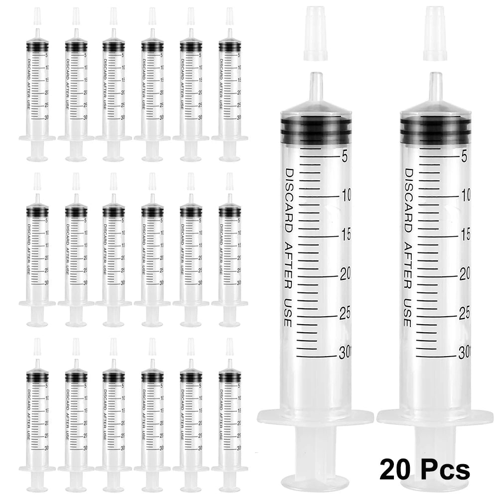 A set of 20 disposable party syringes with lids, featuring graduated markings for measuring liquid.