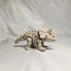 A 3D printed figurine of a dinosaur skeleton, featuring a T-Rex and Mosasaurus design.