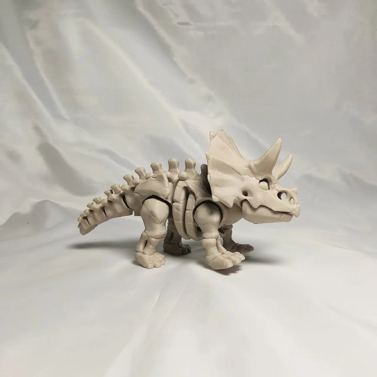 A 3D printed figurine of a dinosaur skeleton, featuring a T-Rex and Mosasaurus design.