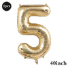 A large gold foil number balloon shaped like the numeral five for birthday and party decoration.
