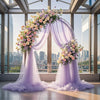 Elegant purple tulle backdrop draped with floral arrangements in a modern glass atrium setting