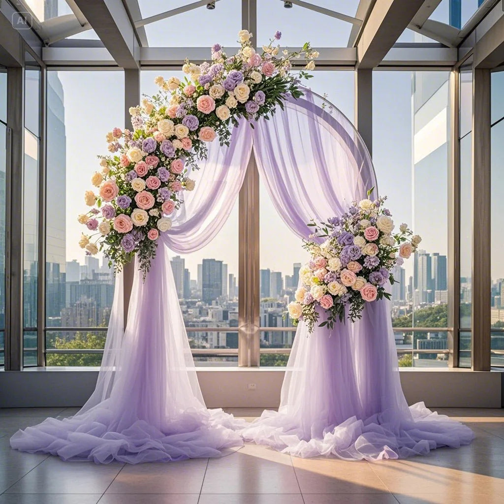 Elegant purple tulle backdrop draped with floral arrangements in a modern glass atrium setting