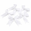 A collection of white satin ribbon bows tied in various decorative styles.