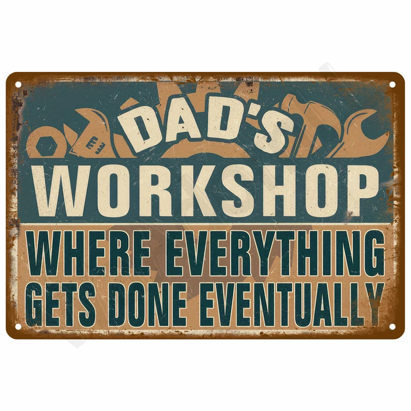A distressed metal sign with the text Dad's Workshop Where Everything Gets Done Eventually on a teal background.