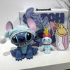 A plush Stitch character toy next to a box featuring the Lilo & Stitch Bluetooth Speaker logo.