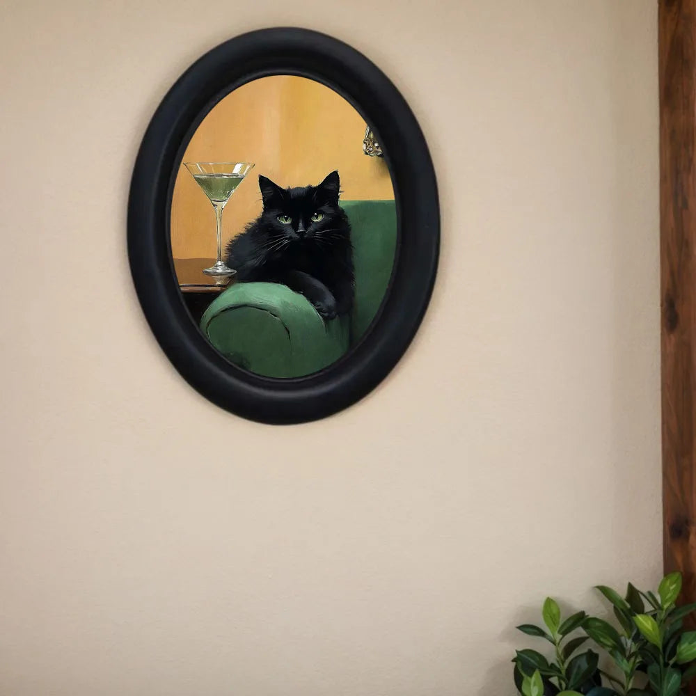 A black cat sitting on a green sofa is reflected in a round mirror hanging on a beige wall.