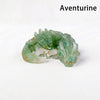 A green Aventurine crystal dragon figurine with gold accents, displayed on a white background.
