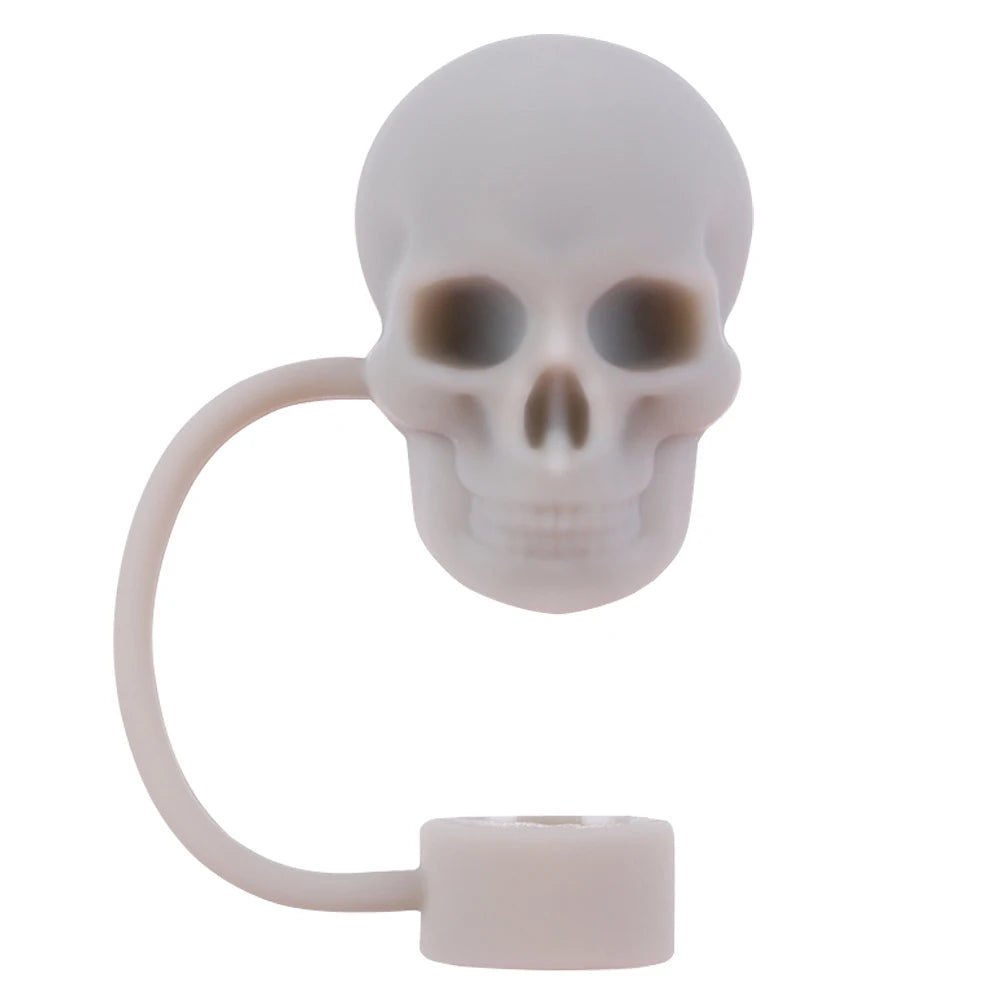 A white silicone straw cover shaped like a skull with a flexible loop and a base.