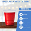 A stack of 300 red plastic shot glasses is shown next to a measuring tape, highlighting their size and durability.