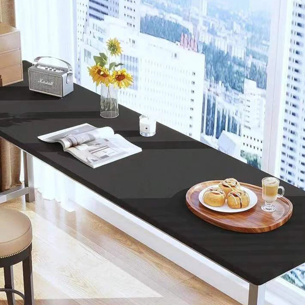A black table displays a matte peel and stick decor sticker set, a small silver box, and a glass vase with yellow flowers nea