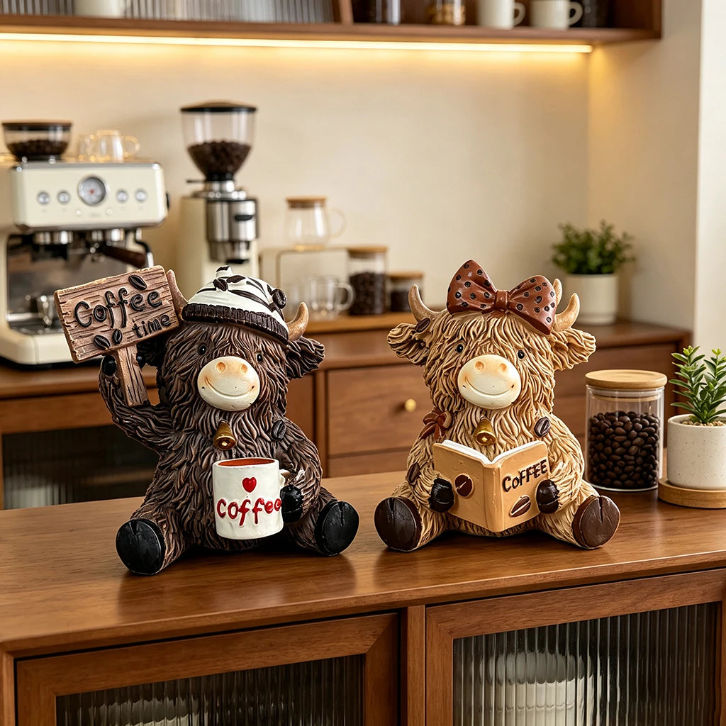 A brown cow figurine dressed as a barista, holding a cup of coffee, sitting on a wooden desk.